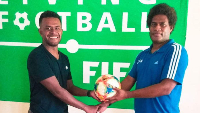 SIFF-Technical-Director,-Moses-Toata-handing-over-a-ball-to-Micah-Leaalafa.-Photo-SIFF-Media