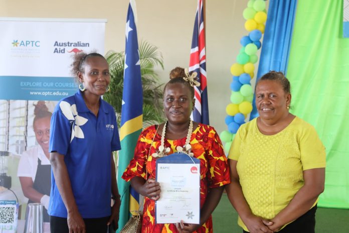 A graduate with her certificate in carpentry