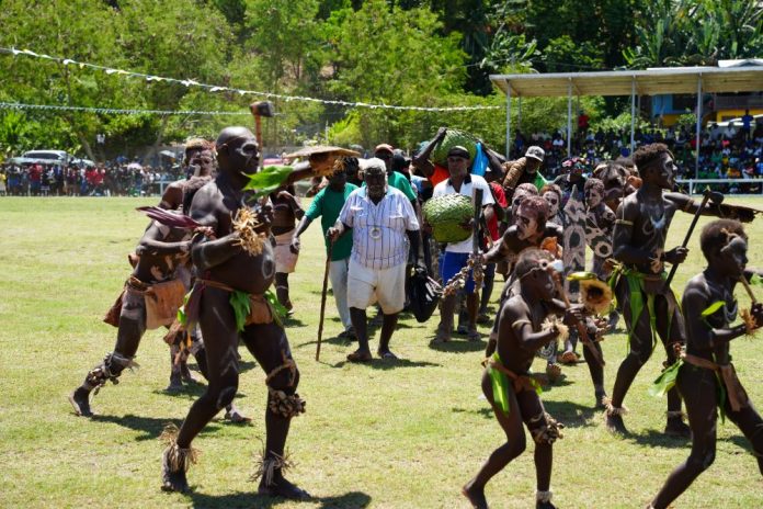 Ranonga chief and troupe presenting their gifts to Minister Ghemu
