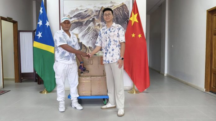 CDO Leslie Lamani Shakes Hands with PRC Representative at Official Handing Over Ceremony.Photo supplied