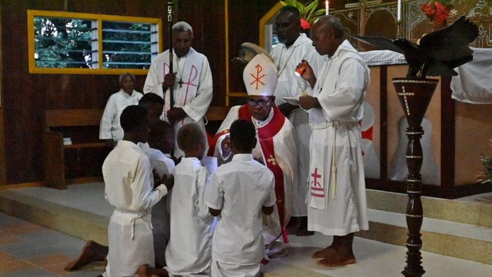 Children receives the sacrament of Confirmation