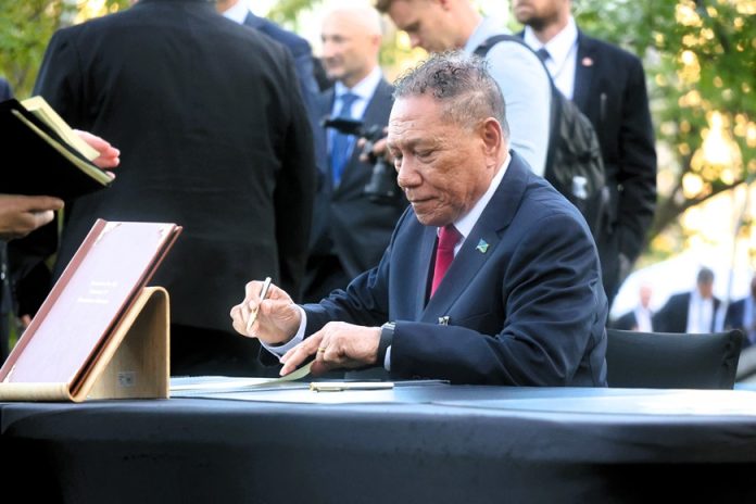 Hon. Peter Shanel Agovaka, siging the declaration