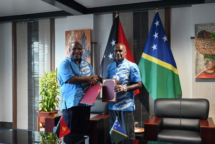 Prime Minister Marape and Prime Minister Manele exchanged the signed document after the signing