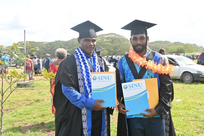 Two male graduand pose for a photo