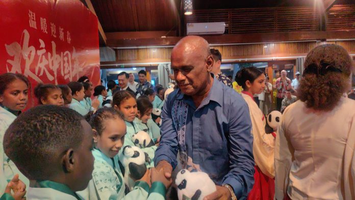 PM Manele hands over gifts to children.