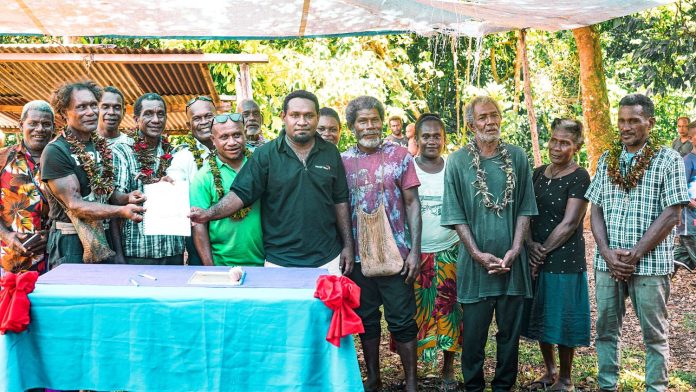 A group photo session during the signing of the bylaw at Kwa'a community