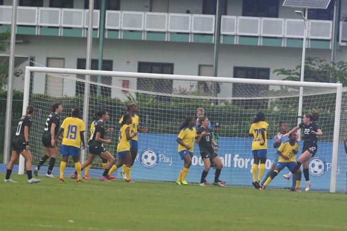 New Zealand's H. Blake 22 jump for a ball heading as both sides looks on during FIFA womens World Cup Qualifiers in Honiara national Stadium yesterday. Photo-credit Tony Iroga