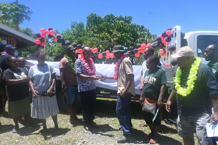 Newly truck key handed over yesterday by MP Morris Toiraena to Koli Farmers Association chairman SImeon as officers and community reps look on.
