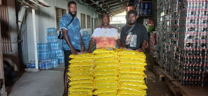 MPA Jenty Isaac centre hands over bags of rice to his Ward Committee