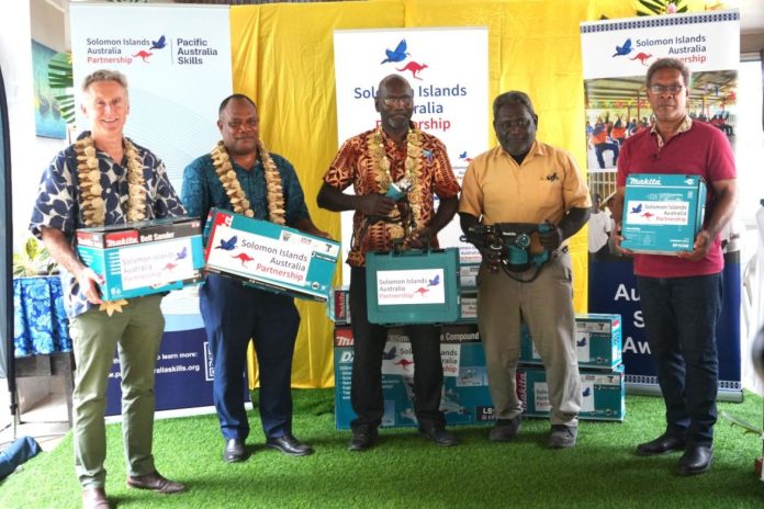 Australia's High Commissioner to Solomon Islands, His Excellency Jeff Roach hands over electrical tools to SINU as MEHRD Minister looks on. Photo credit-SINU