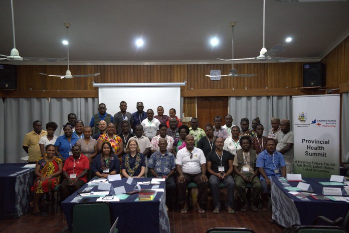 Officials and participants pose for a group photo before the summit begin