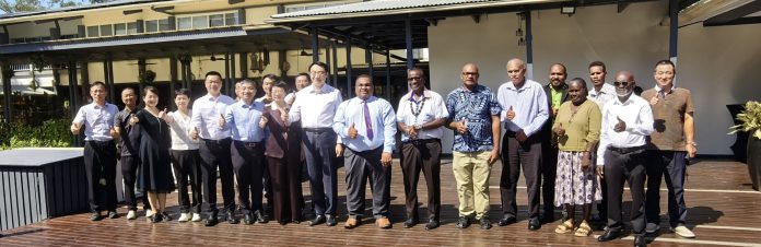 Officials pose for a group photo following the handover of agricultural equipment and the signing of agreements aimed at strengthening agricultural cooperation. Pictures by NED GAGAHE.
