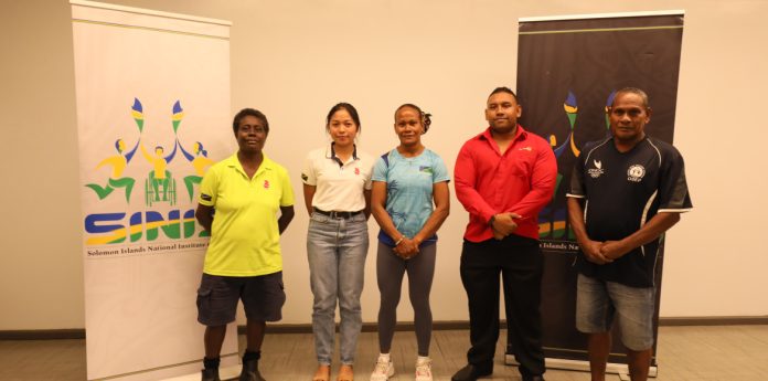 Commonwealth Games weightlifter Jenly Wini (centre) poses with representatives of Delite Industries Ltd, Solomon Telekom Compa